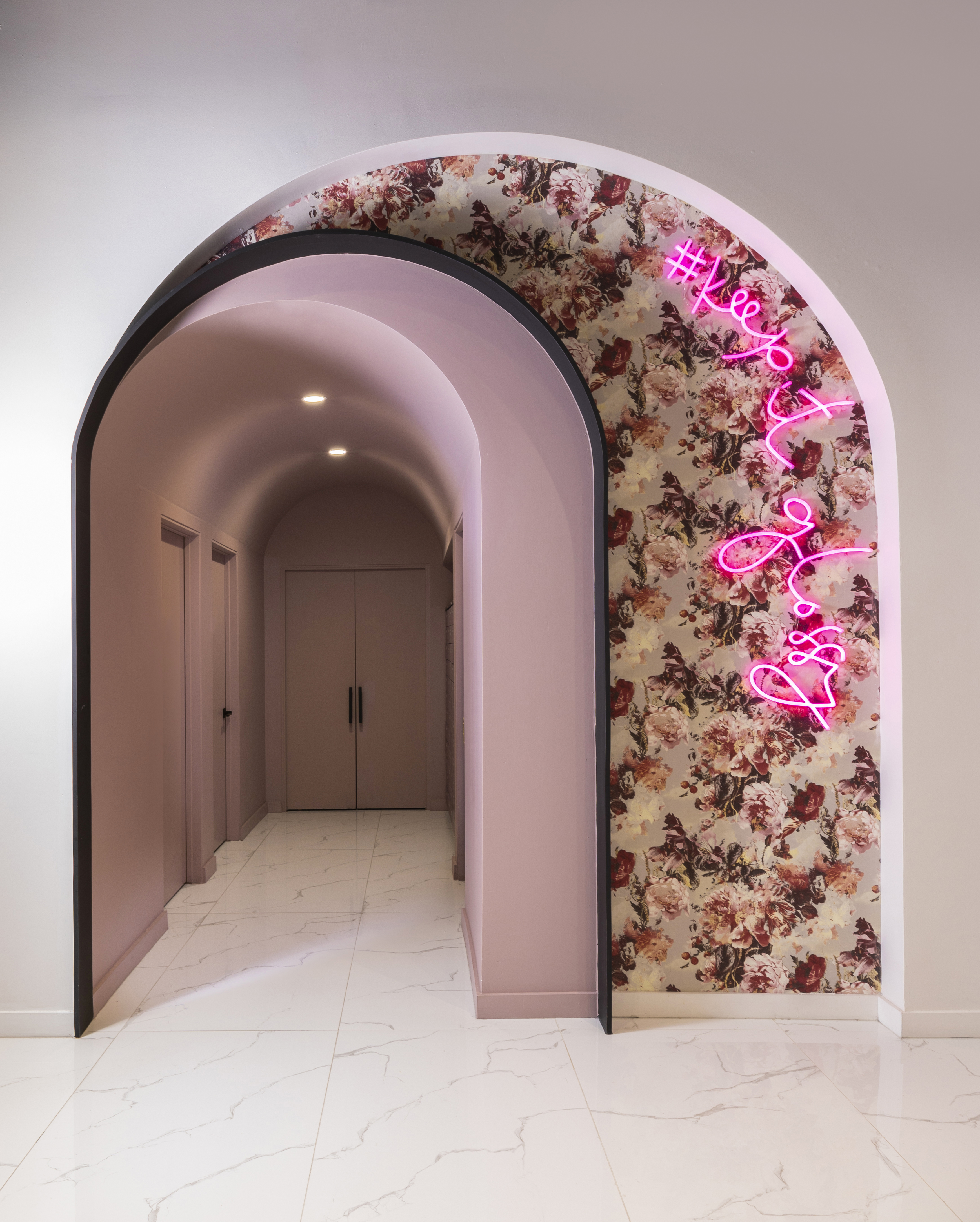 Floral archway with Keep It Glossy neon sign at Gloss Nail Bar