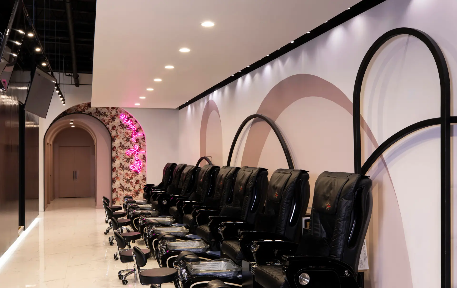 Pedicure area with neon archway at Gloss Nail Bar Houston